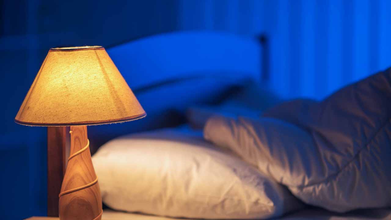 The lamp against the background of the bed. night time